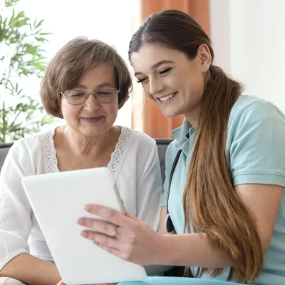 medium-shot-smiley-women-looking-tablet